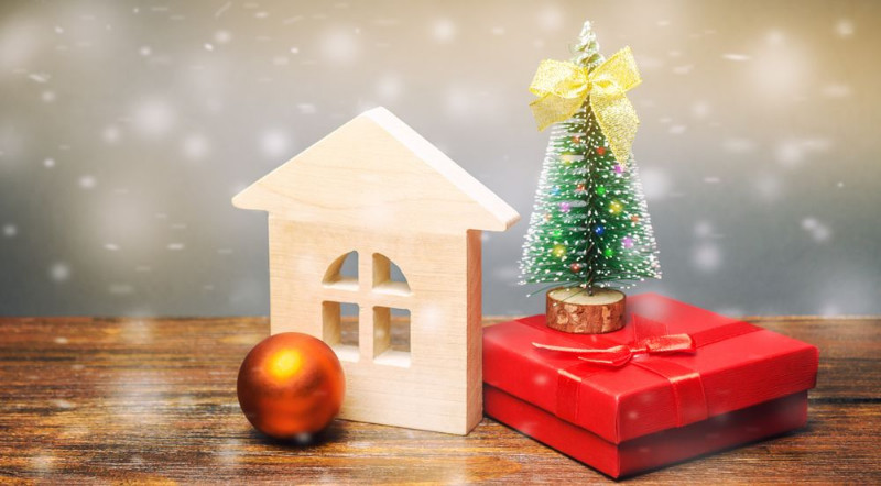 Small house model with a Christmas ball and tree